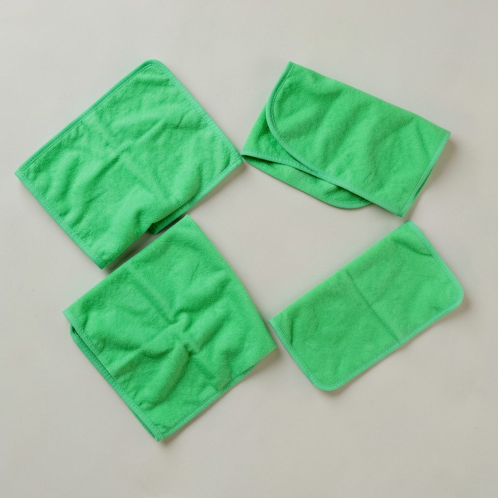 Multi-purpose cleaning wet wipes in branded packaging, white and green accents, household setting