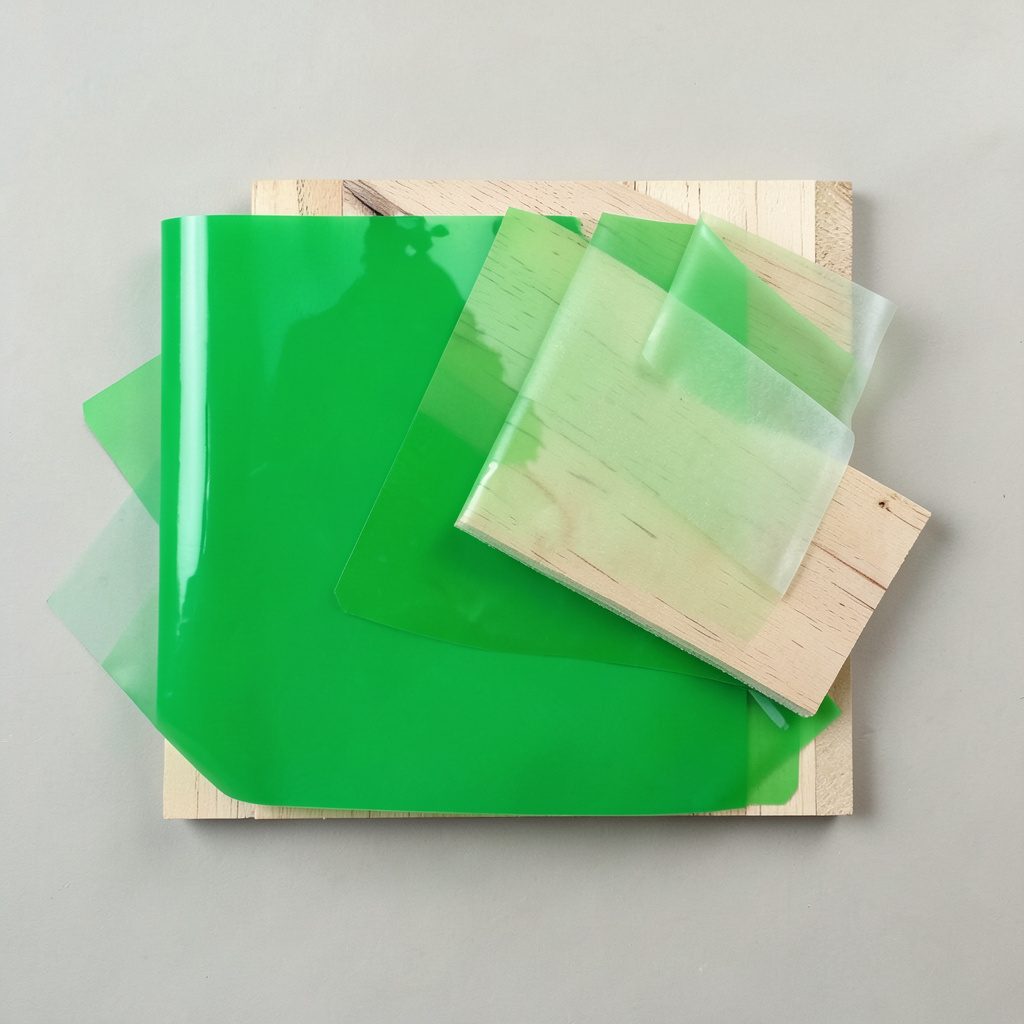 Close-up of waterproof film-faced plywood surface showing dark phenolic coating and wood grain texture